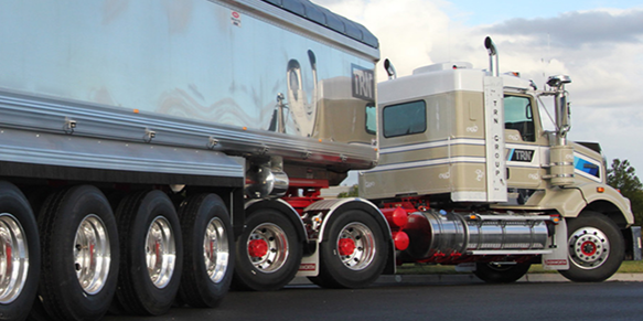 Two trucks in front of a mountain